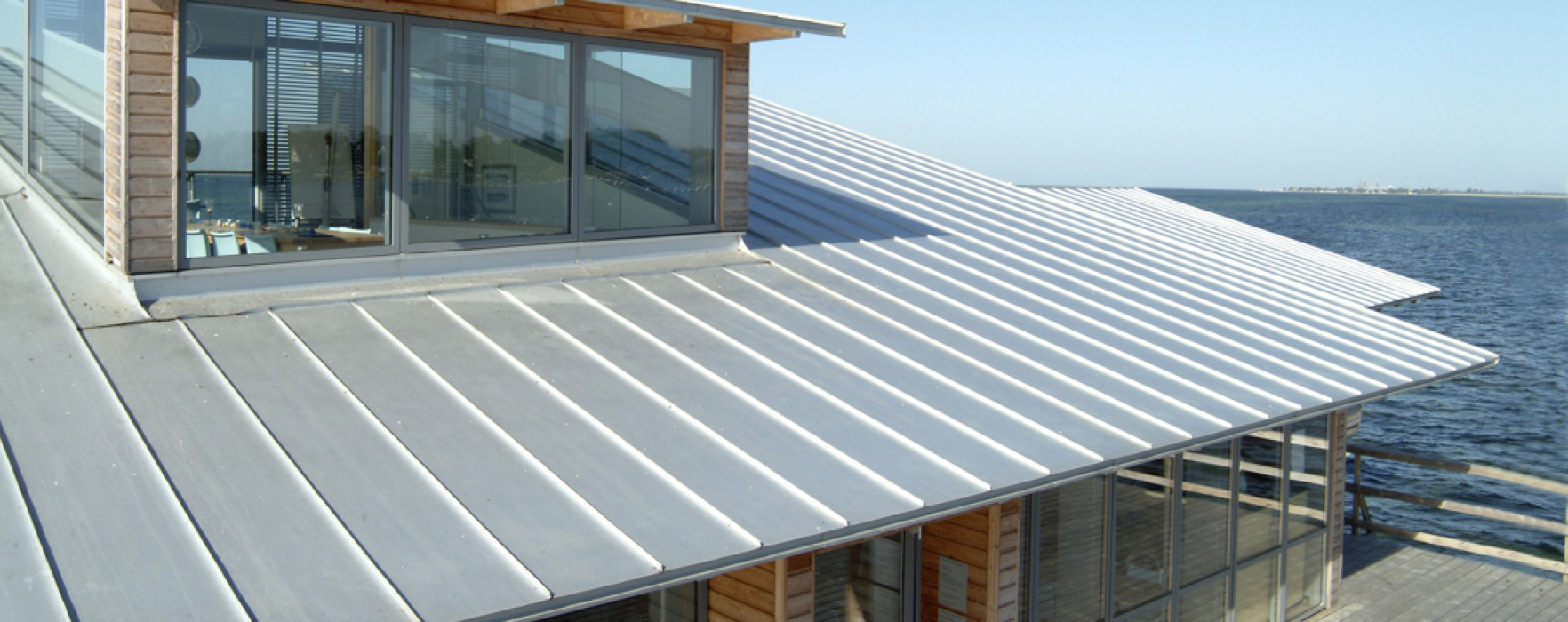 Modern building with a metal roof by the sea